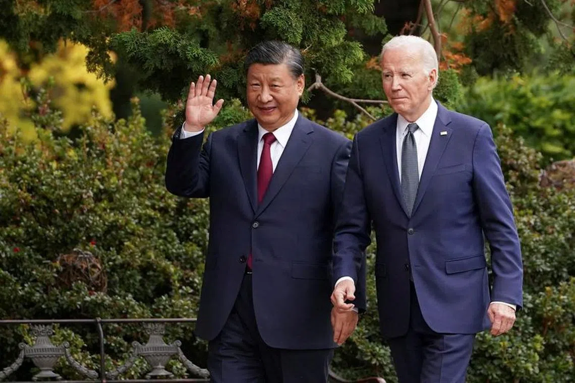 FILE PHOTO: Chinese President Xi Jinping waves as he walks with U.S. President Joe Biden at Filoli estate on the sidelines of the Asia-Pacific Economic Cooperation (APEC) summit, in Woodside, California, U.S., November 15, 2023. REUTERS/Kevin Lamarque/File Photo