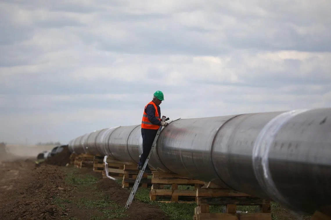 FILE PHOTO: A worker is seen next to a pipe at a construction site on the extension of Russia's TurkStream gas pipeline in Letnitsa, Bulgaria, June 1, 2020. REUTERS/ Stoyan Nenov/File Photo