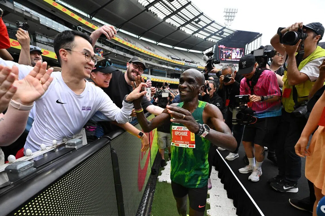 Eliud Kipchoge of Kenya celebrates with the spectators after crossing the finish line to win the 2026 Melbourne Marathon on Oct 11.