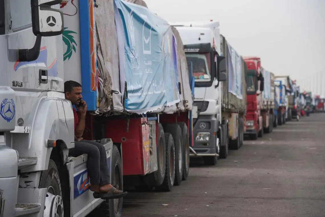 FILE PHOTO: Trucks carrying humanitarian aid to Palestinians, wait on the desert road (Cairo - Ismailia) on their way to the Rafah border crossing to enter Gaza, amid the ongoing conflict between Israel and the Palestinian Islamist group Hamas, in Cairo, Egypt, November 12, 2023. REUTERS/Hadeer Mahmoud/File photo