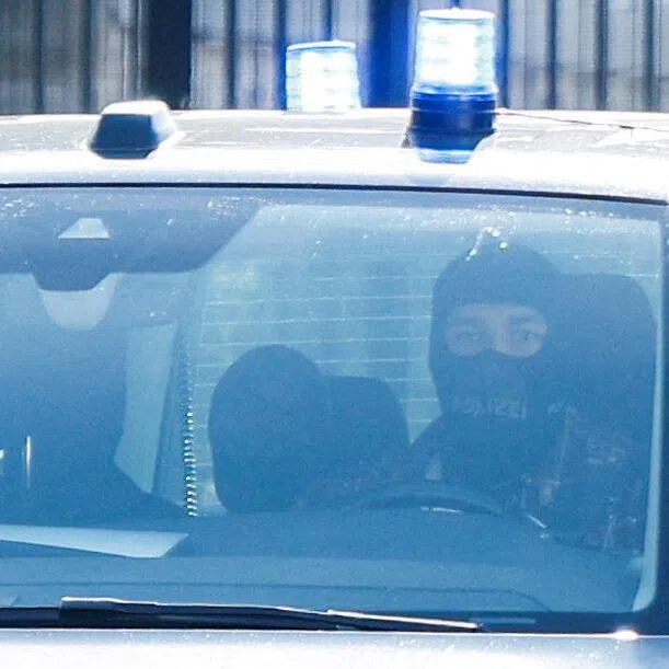 Police officers leaving the Federal Court of Justice in Karlsruhe, Germany, on Oct 7, following the detention of former German foreign intelligence chief August Hanning.