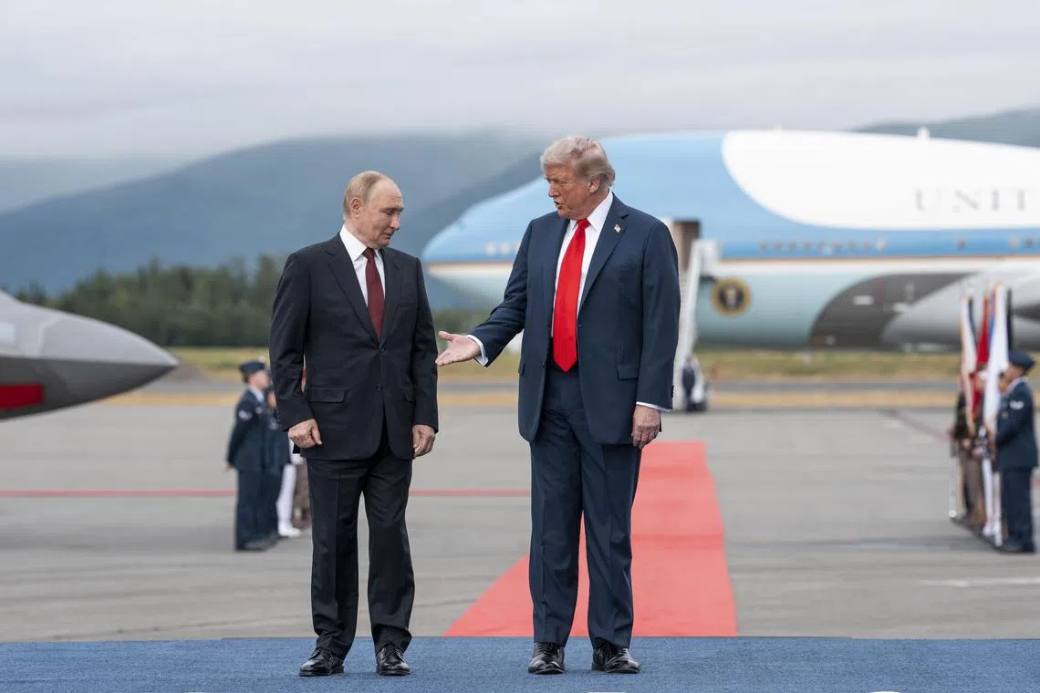 President Donald Trump reaches for a handshake with Russian President Vladimir Putin in Anchorage, Alaska, on Aug 15.