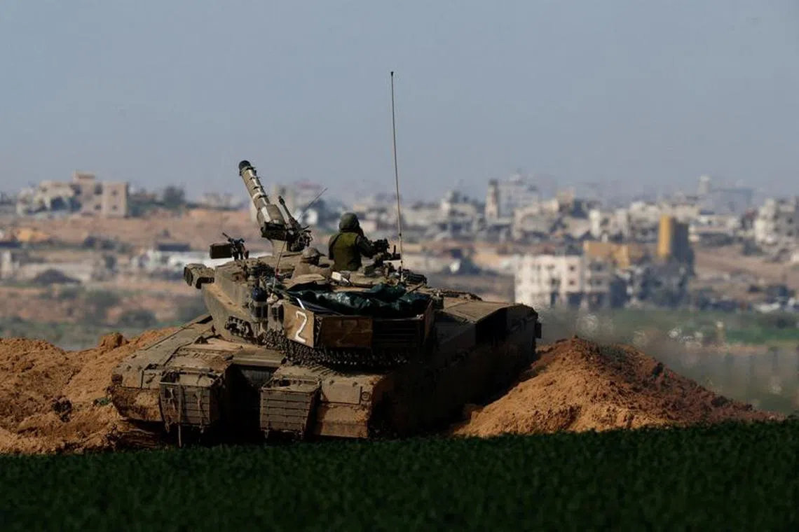 FILE PHOTO: An Israeli tank manoeuvres along the border with northern Gaza, amid the ongoing conflict between Israel and the Palestinian Islamist group Hamas, in Israel, January 30, 2024. REUTERS/Amir Cohen