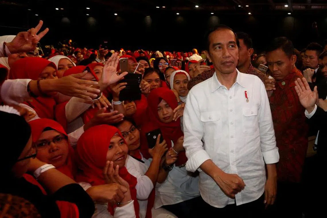 FILE PHOTO: Indonesian President Joko \"Jokowi\" Widodo is greeted by Indonesian migrant workers in  Hong Kong, China, April 30, 2017.      REUTERS/Bobby Yip/File Photo