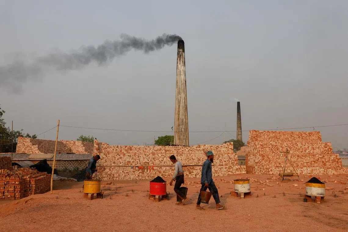 Smoke rises from the chimneys of brick factories on the outskirts of Dhaka, Bangladesh, March 17, 2024. REUTERS/Mohammad Ponir Hossain