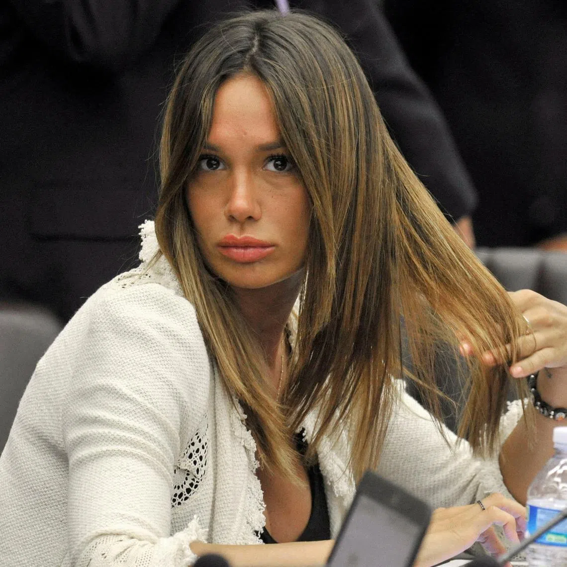 FILE PHOTO: Nicole Minetti gestures during Lombardy regional council in Milan July 17, 2012. Minetti, a former showgirl and dental hygenist at the center of Berlusconi's \" Rubygate\" sex scandal, is being forced out of the job he acquired for her on the Lombardy regional council because she is seen as too much of a liability.   REUTERS/Paolo Bona/File Photo