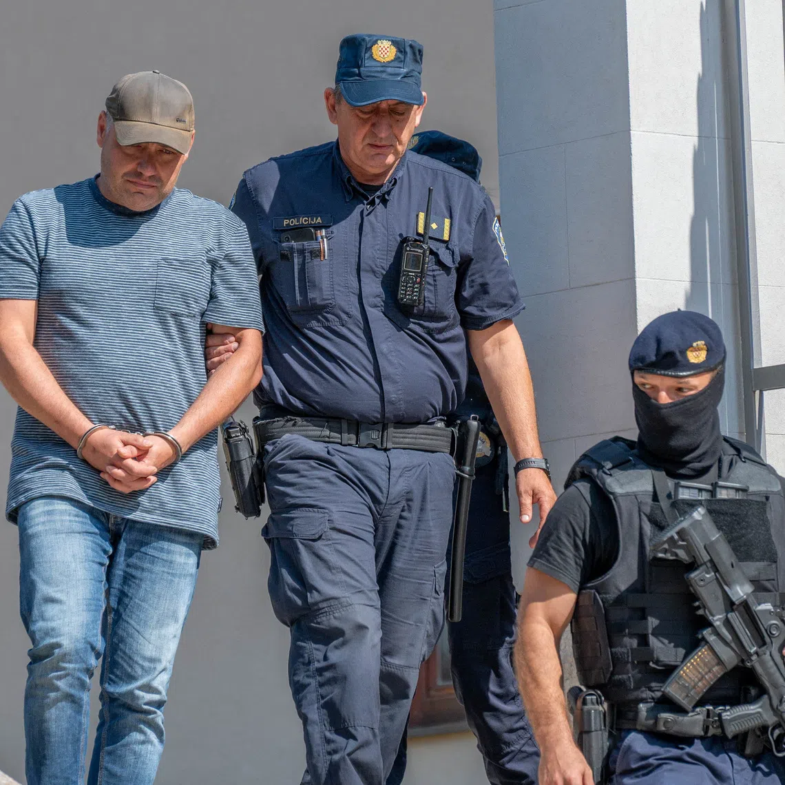 Police escort Vladimir Z. after a court hearing in Pula, Croatia, August 20, 2026. REUTERS/Stringer
