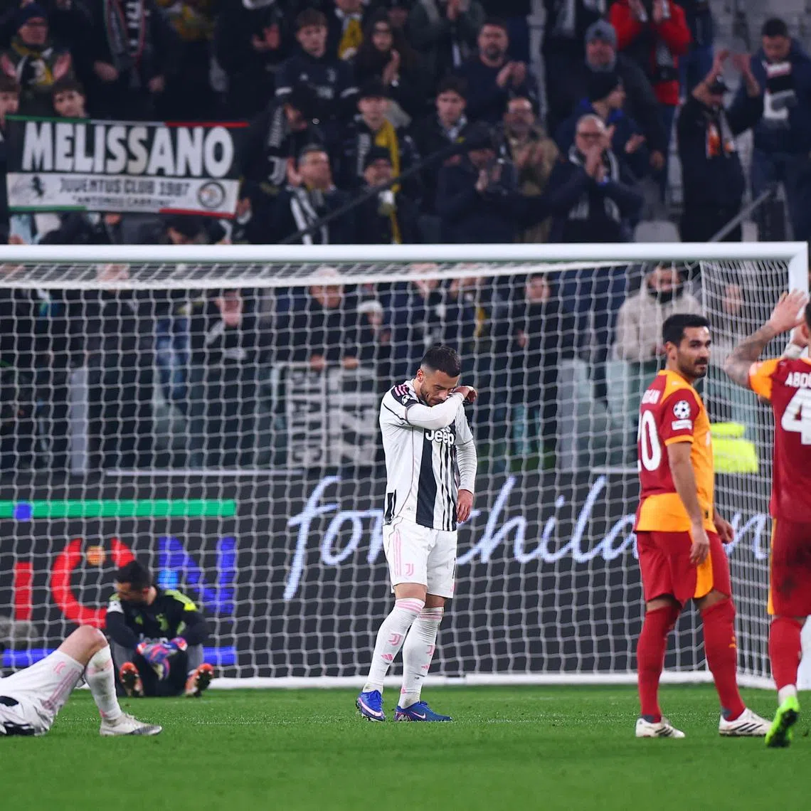 Soccer Football - UEFA Champions League - Play Off - Second Leg - Juventus v Galatasaray - Allianz Stadium, Turin, Italy - February 25, 2026 Juventus' Edon Zhegrova and Filip Kostic look dejected after the match as Galatasaray's Ilkay Gundogan, Abdulkerim Bardakci and Mauro Icardi celebrate REUTERS/Guglielmo Mangiapane