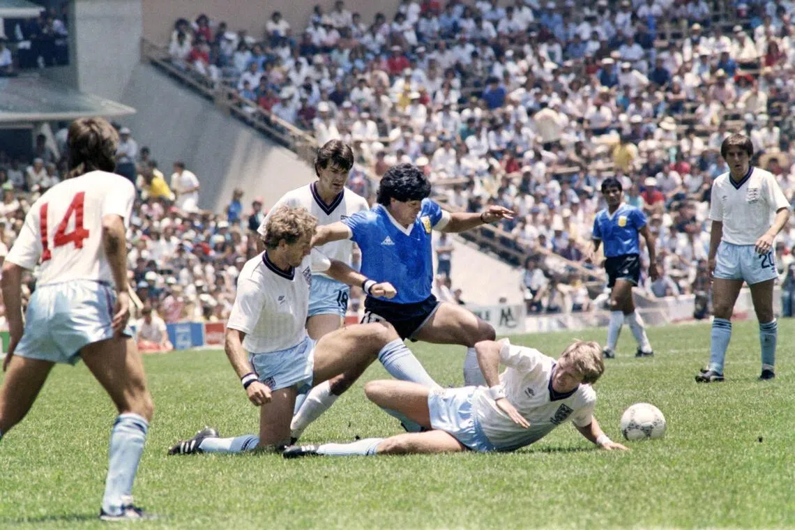 Argentina's Diego Maradona dribbles past three English defenders on June 22, 1986 in Mexico City during their World Cup quarter-final match.