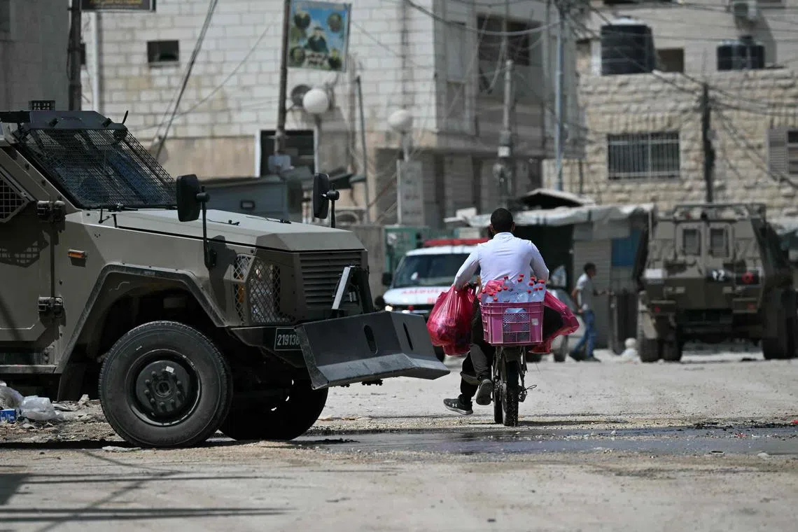 Israeli armoured vehicles in Jenin in the occupied West Bank during an army raid on Aug 31.