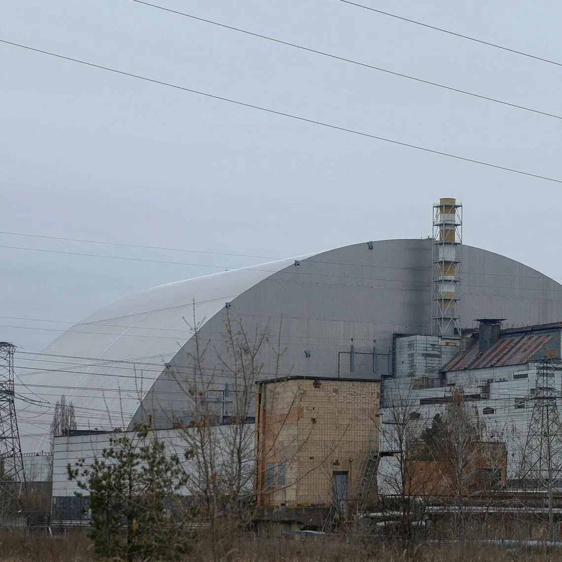 FILE PHOTO: A general view shows the New Safe Confinement (NSC) structure, that covers the old sarcophagus which confines the remains of the damaged fourth reactor, at the Chornobyl Nuclear Power Plant, amid Russia's attack on Ukraine, in Kyiv region, Ukraine April 12, 2025.  REUTERS/Valentyn Ogirenko/File Photo