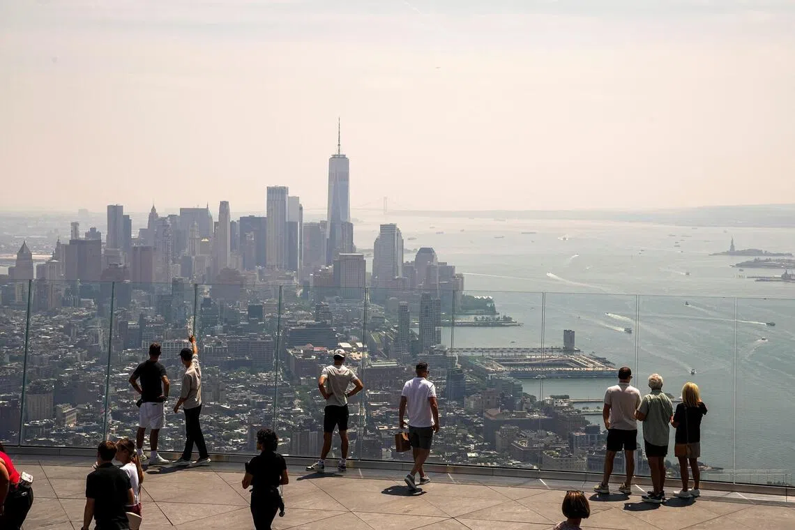 People visiting the Edge observation deck to view the New York City skyline and One World Trade Centre, as wildfire smoke impacts air quality in New York City on July 17.