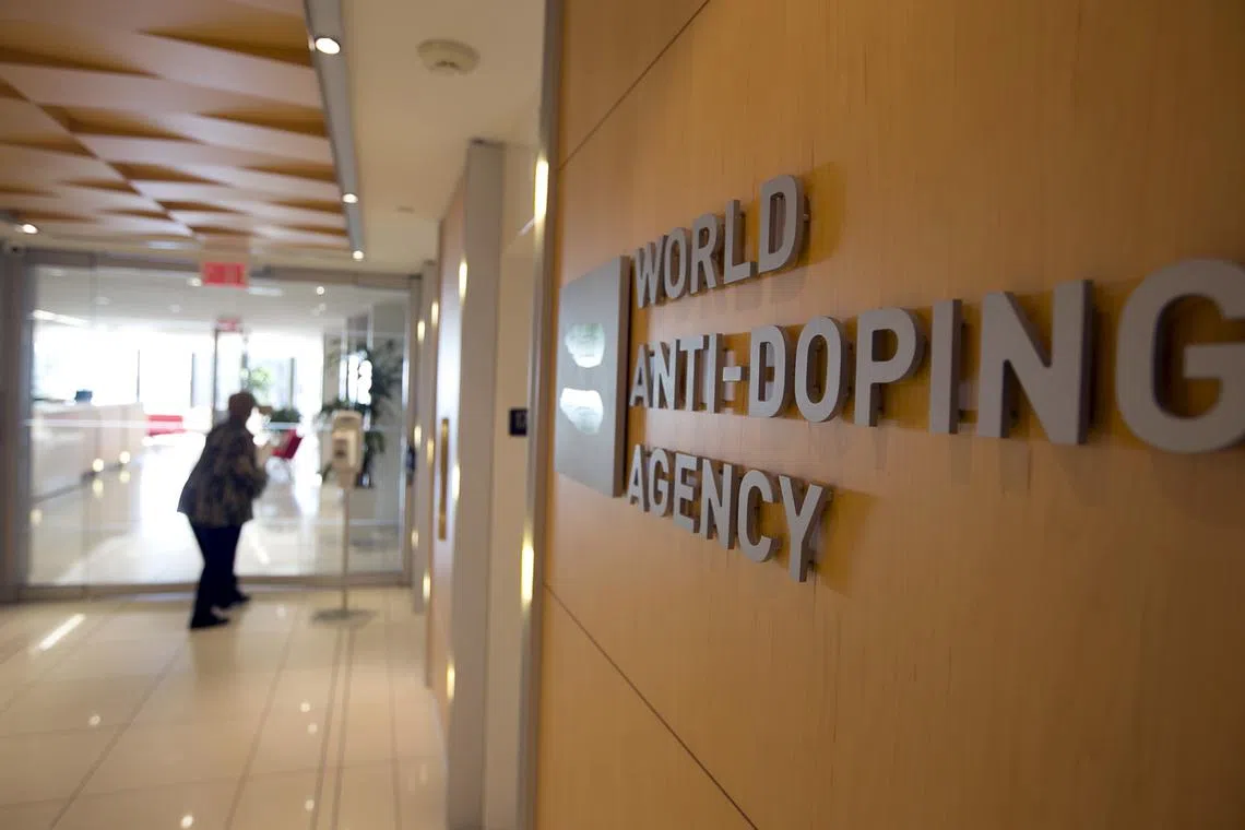 FILE PHOTO: A woman walks into the head office for the World Anti-Doping Agency (WADA) in Montreal, November 9, 2015. REUTERS/Christinne Muschi/File Photo