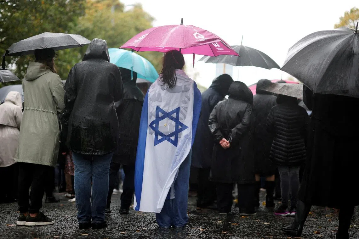 People attending a vigil in October 2025 for the victims of a deadly knife and gun attack at a synagogue in Britain’s northern city of Manchester.