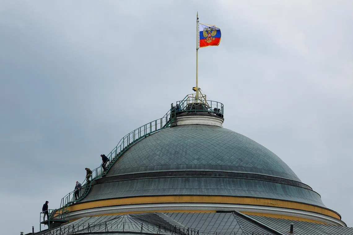 People gather on the dome of the Kremlin Senate building in central Moscow, Russia, May 3, 2023. REUTERS/Evgenia Novozhenina/File Photo