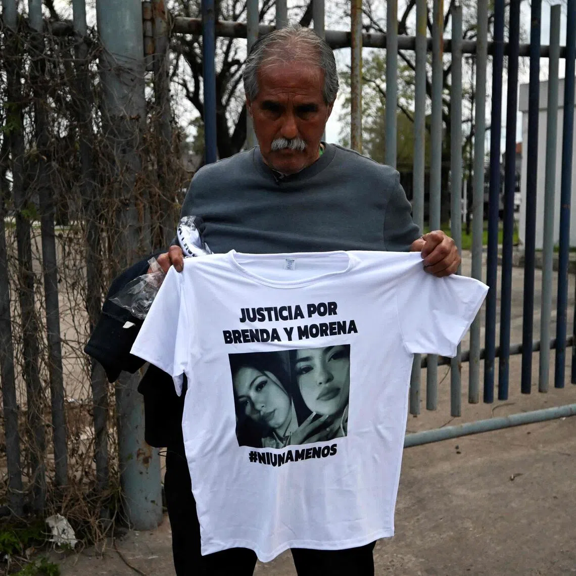 Mr Antonio Del Castillo, grandfather of two of the victims, holding up a shirt with their images. The murder of three women had been livestreamed on Instagram, with the crime linked to narco activity.