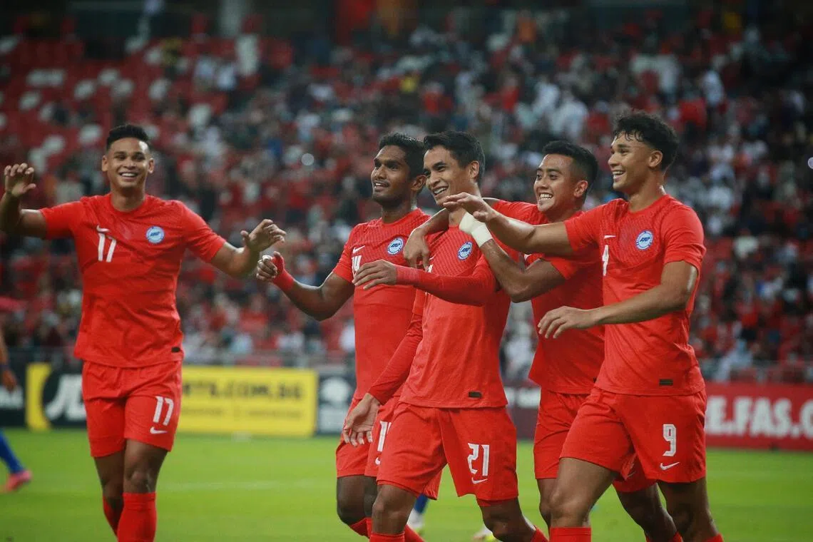 Singapore’s Safuwan Baharudin (No. 21) and Ikhsan Fandi (No. 9), seen here celebrating in a friendly in 2022 alongside (from left) Irfan Fandi, Hariss Harun and Amy Recha.