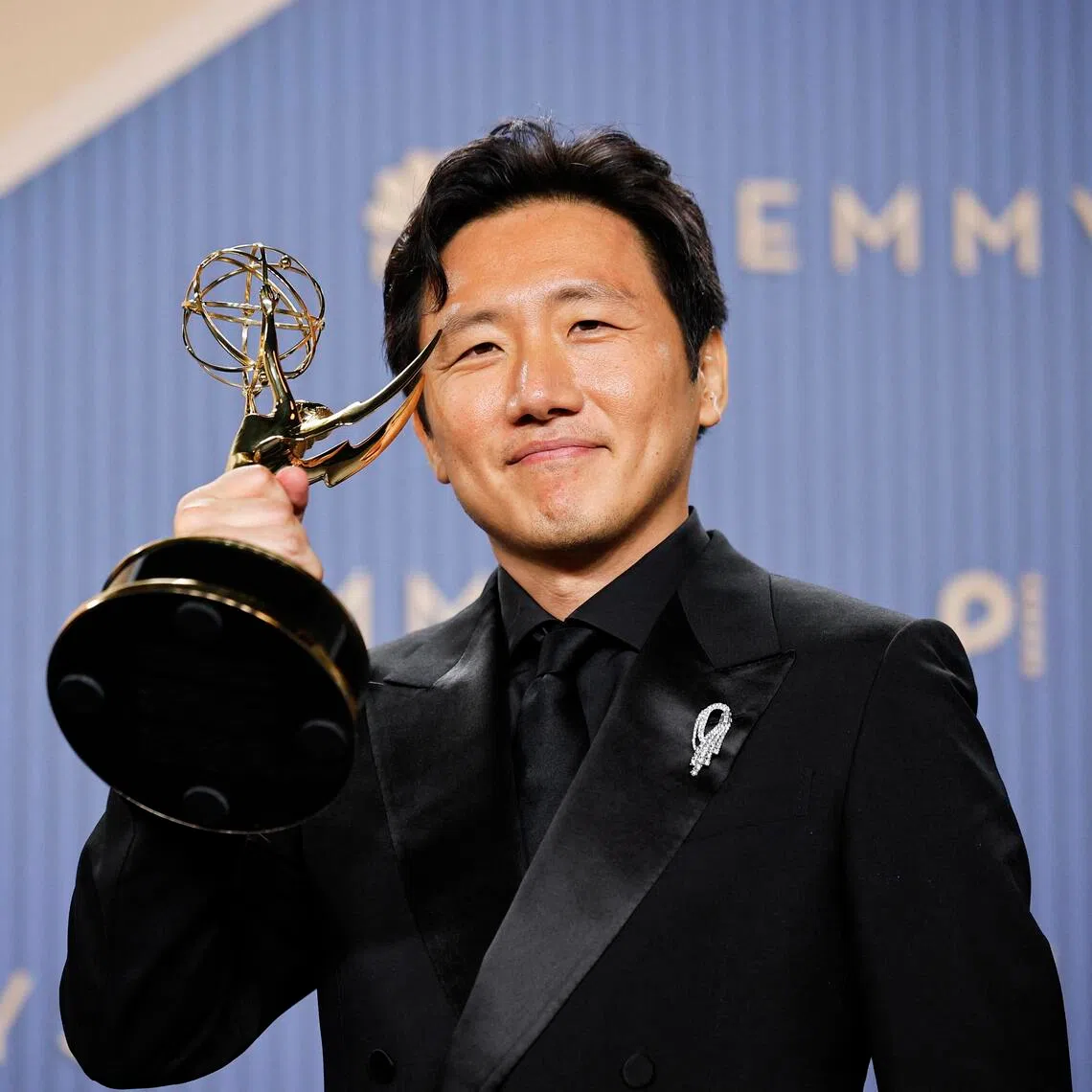 Hiro Murai poses with the award for Outstanding Directing for a Comedy Series for Widow’s Bay during the 78th Primetime Emmy Awards in Los Angeles on Sept 14.