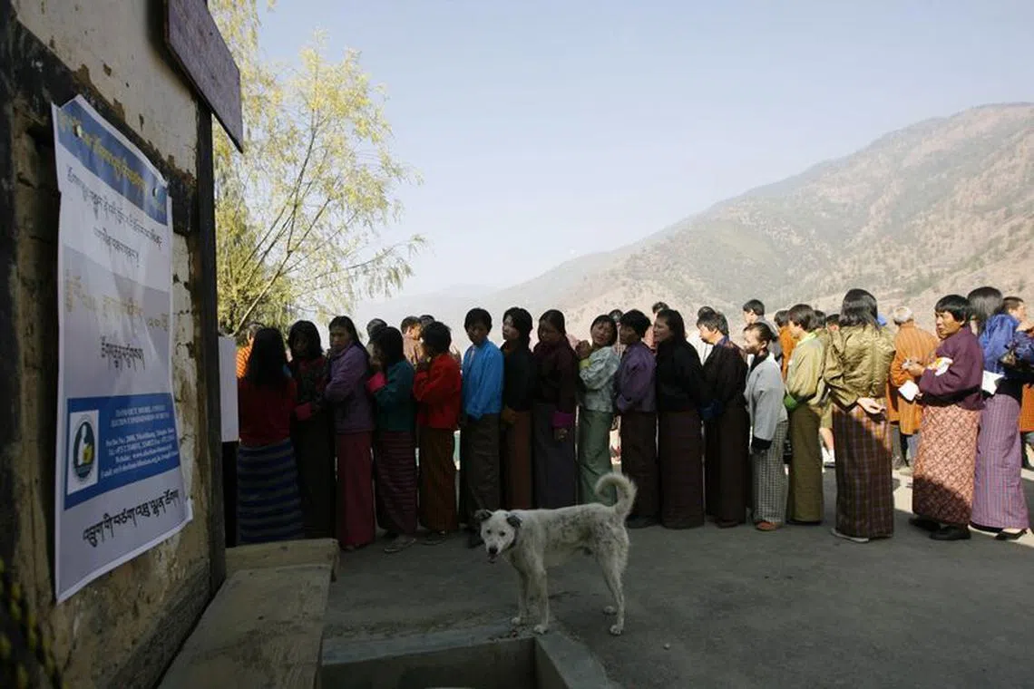 FILE PHOTO: Bhutanese voters stand in a queue outside a polling station to cast their ballot in Thimpu March 24, 2008. REUTERS/Desmond Boylan/File Photo
