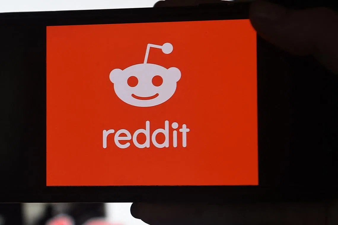 (FILES) This photo illustration shows the logo of Reddit on a mobile phone in Arlington, Virginia on January 29, 2021. The Reddit social network said March 20, 2024 it had priced at the top of its expected range ahead of going public on the New York Stock Exchange, in a sign of enthusiasm by investors. Reddit, set to debut March 21 under the ticker "RDDT", was put at $34 dollars a share, the company said in a statement, which would value the platform at around $6.4 billion according to the US media. (Photo by Olivier DOULIERY / AFP)
