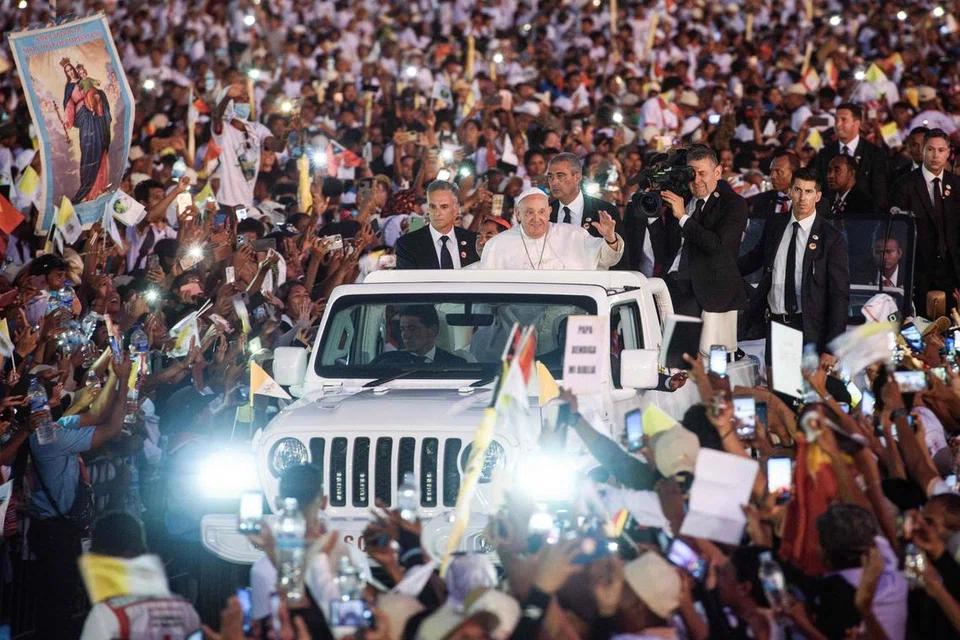 Pope Francis waving to the faithful after leading mass at the Esplanade of Tasitolu in Dili on Sept 10. PHOTO: AFP