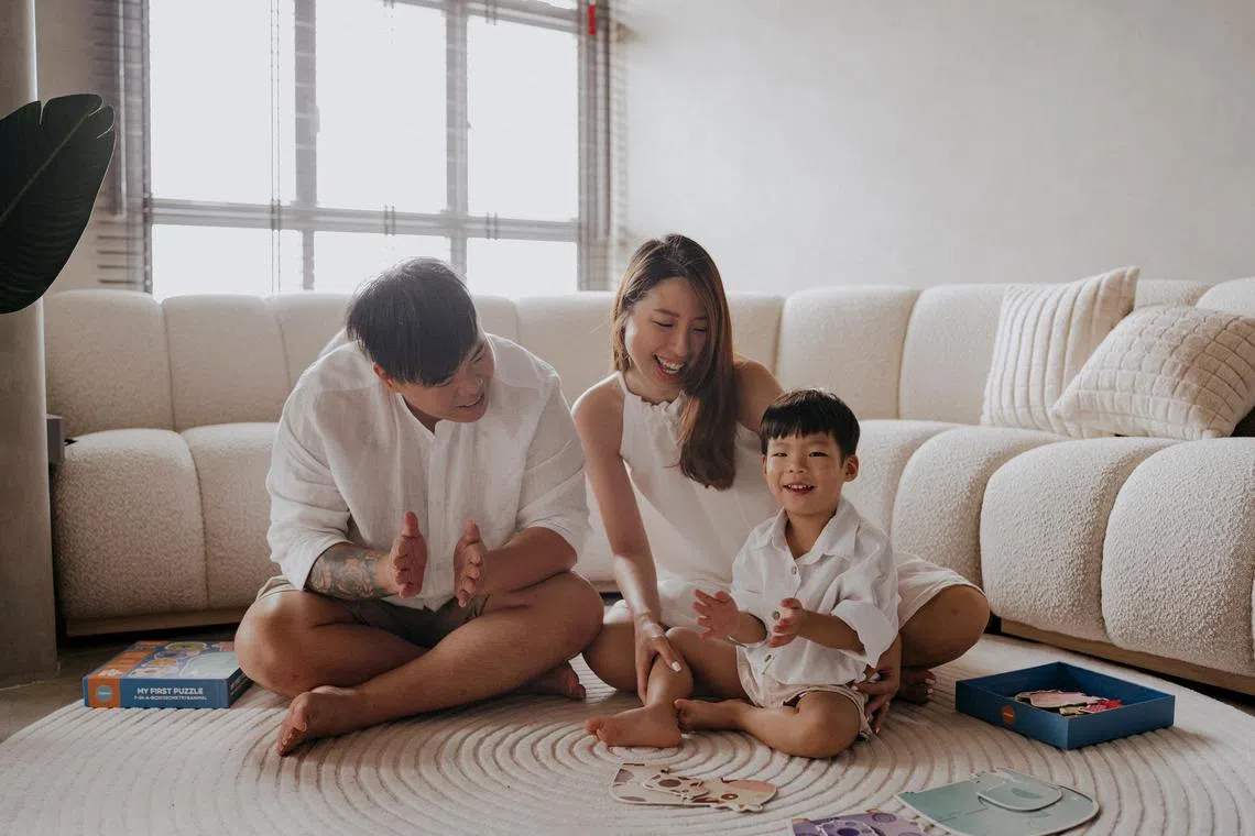 Comedian, singer and interior design entrepreneur Kelvin Tan with his wife and son.