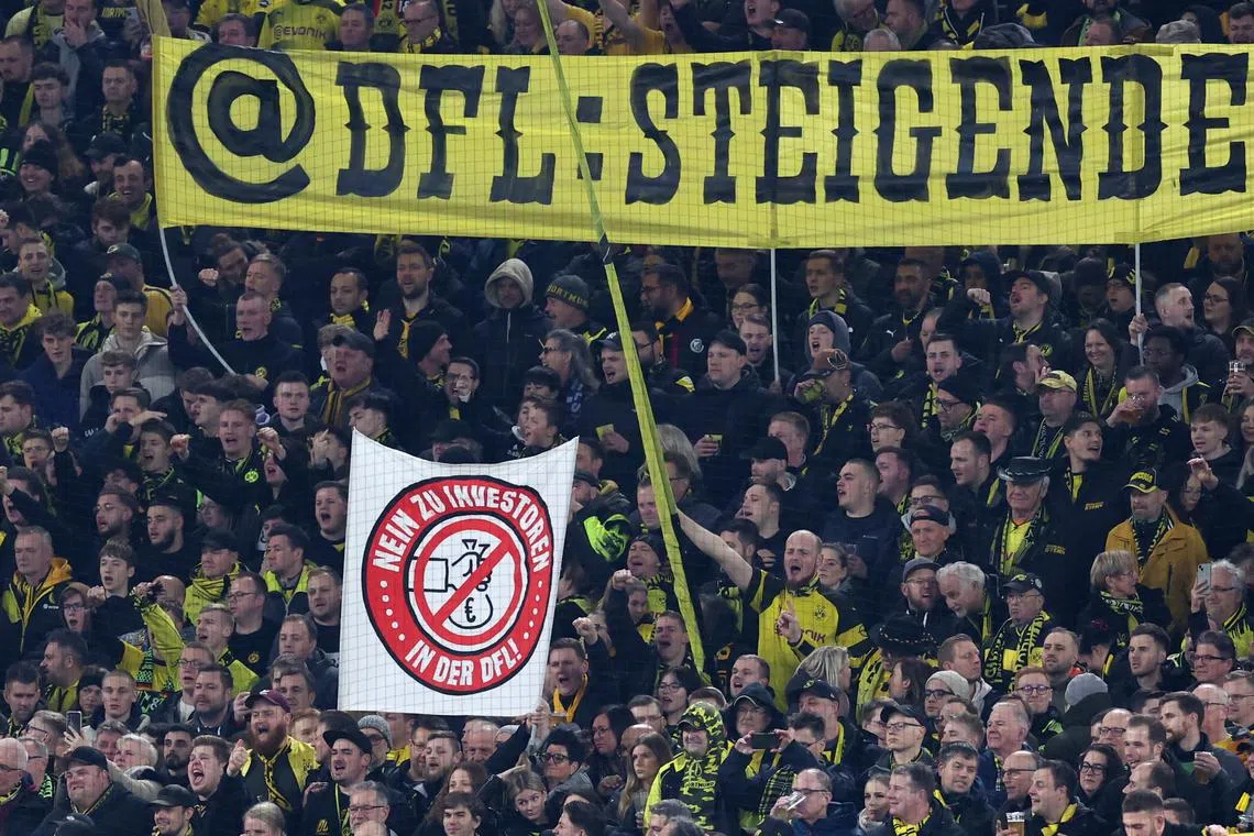 Dortmund fans hold banners to protest saying “no to investors in DFL” during the Bundesliga soccer match between Borussia Dortmund and SC Freiburg, in Dortmund, on Feb 9.