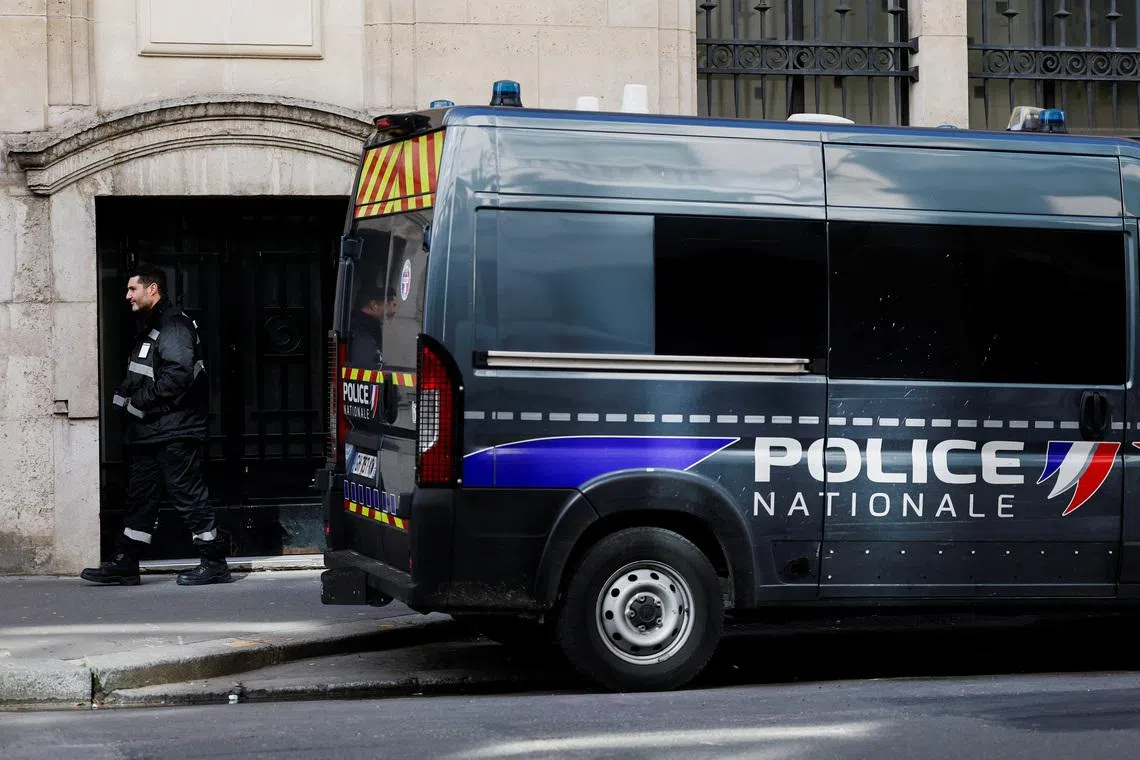 A private security member stands next to a police van outside Bank of America’s Paris offices, after French anti-terrorism prosecutors opened an investigation into attempted destruction by fire or other dangerous means in Paris, France, March 30, 2026. REUTERS/Benoit Tessier