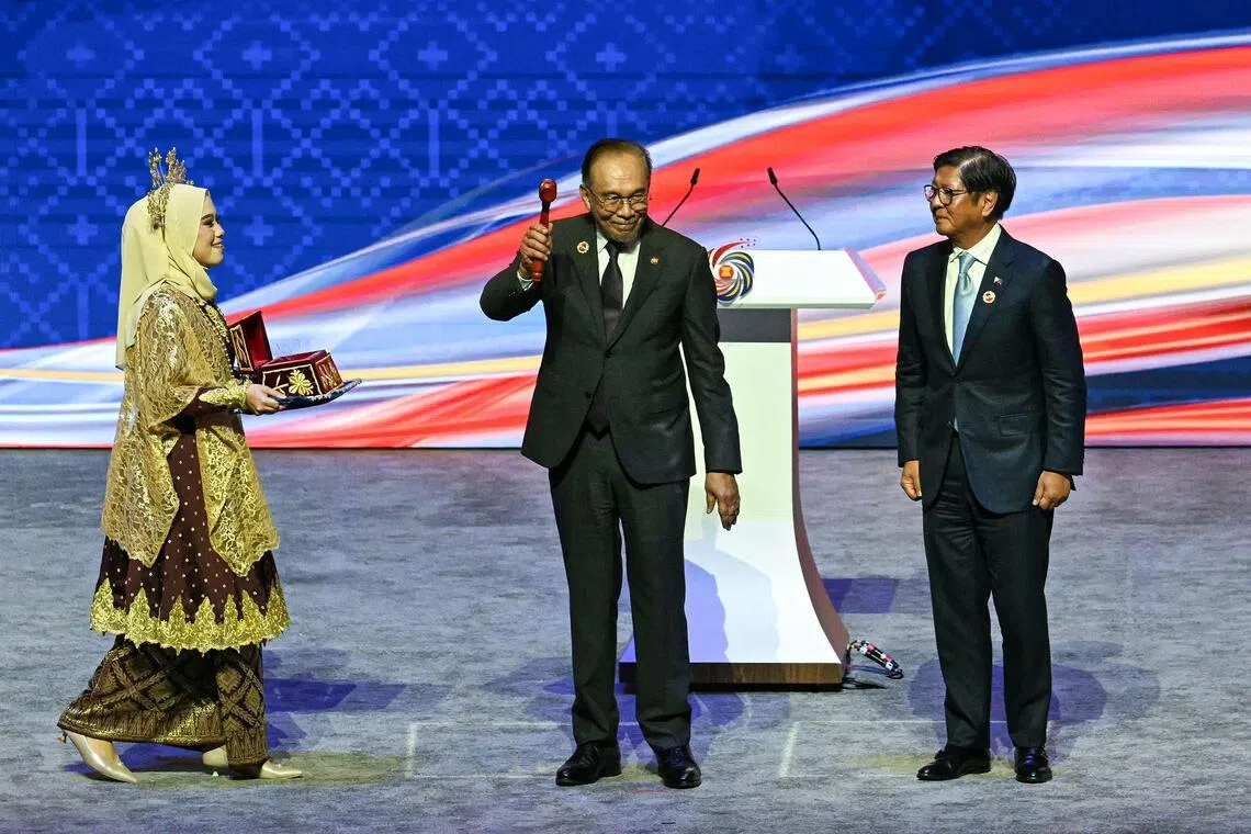 Malaysian Prime Minister Anwar Ibrahim (with gavel) during a symbolic handover of the Asean chairmanship to Philippine President Ferdinand Marcos Jr in Kuala Lumpur on Oct 28.