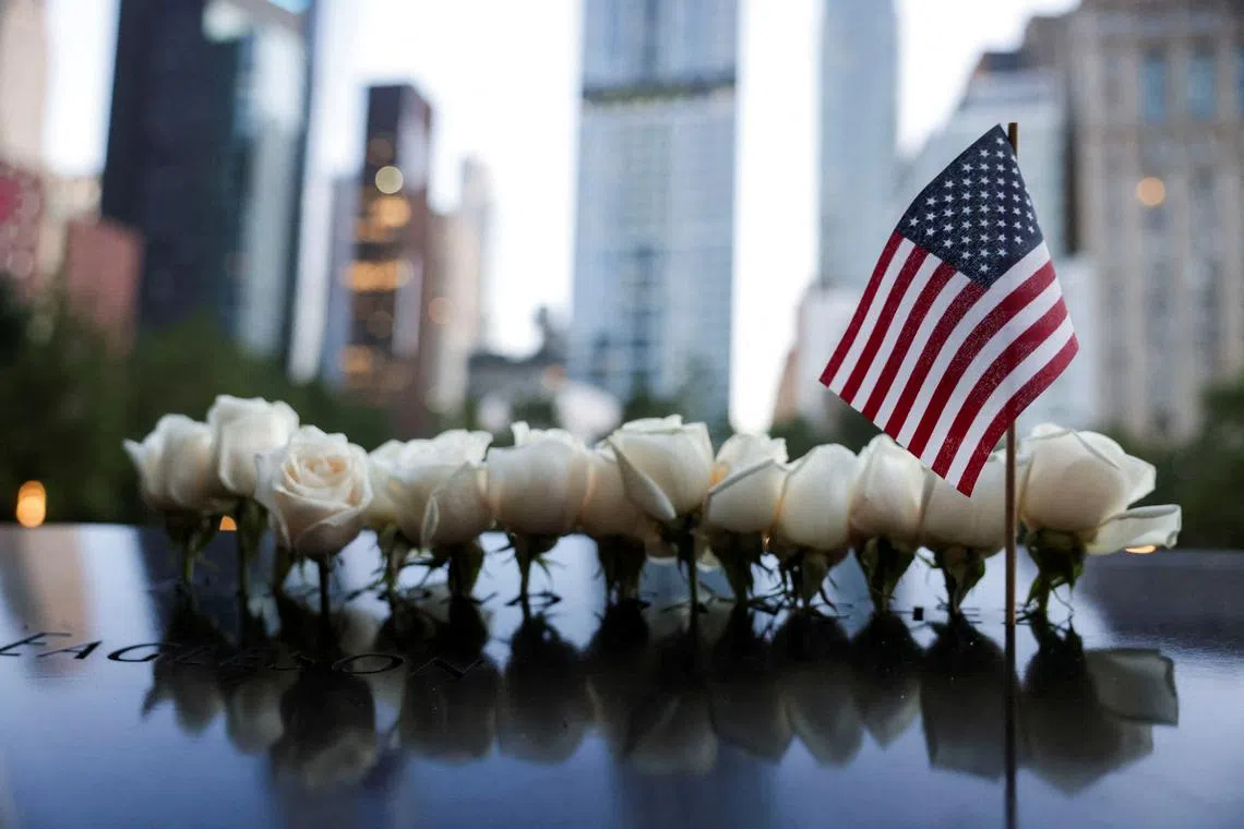 FILE PHOTO: A U.S. national flag and flowers are placed at the 9/11 Memorial and Museum pool on the day of the 23rd anniversary of the September 11, 2001 attacks on the World Trade Center, in the Manhattan borough of New York City, U.S., September 11, 2024. REUTERS/Kent J.Edwards/File Photo