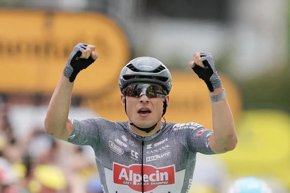 Alpecin-Deceuninck's Belgian rider Jasper Philipsen cycling to the finish line to win the 13th stage of the 111th edition of the Tour de France cycling race on July 12.