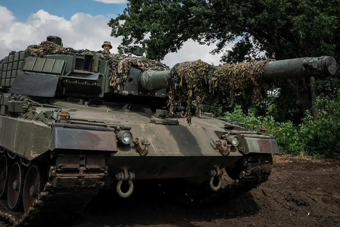 A Ukrainian serviceman test drives a Leopard 2A4 tank at an undisclosed location in the east of Ukraine.