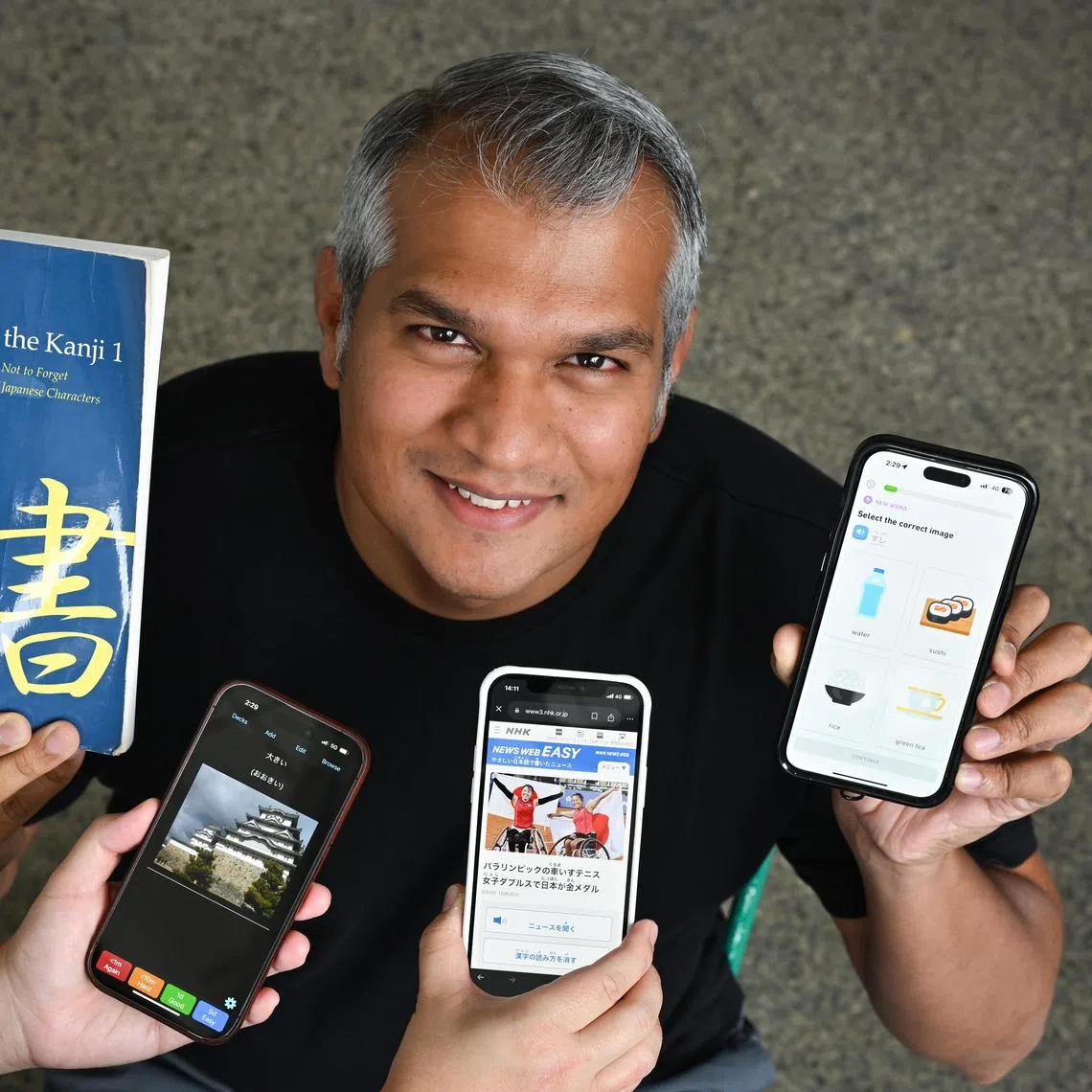 ST20240910-202448000746-Lim Yaohui-Hazel Tang-htlang/
(From left) Mr Qamar Tahasildar, 35, Strategy and Analytics Manager, showing Remembering the Kanji 1 book, Anki app, NHK Web Easy news website, and Duolingo app, outside The National Library on Sept 10, 2024.
Is it possible to learn a new language using just a language application? If not, how effective are these apps, what are their limitations and strengths, and most importantly, why are they so popular?
Mr Qamar Tahasildar, 35, Strategy and Analytics Manager, will show the different applications – Duolingo, Anki, Pimsleur - he uses to learn Japanese. He will also show the additional textbooks/he purchases to study Kanji; the adapted Chinese characters use in Japanese.
(ST PHOTO: LIM YAOHUI)