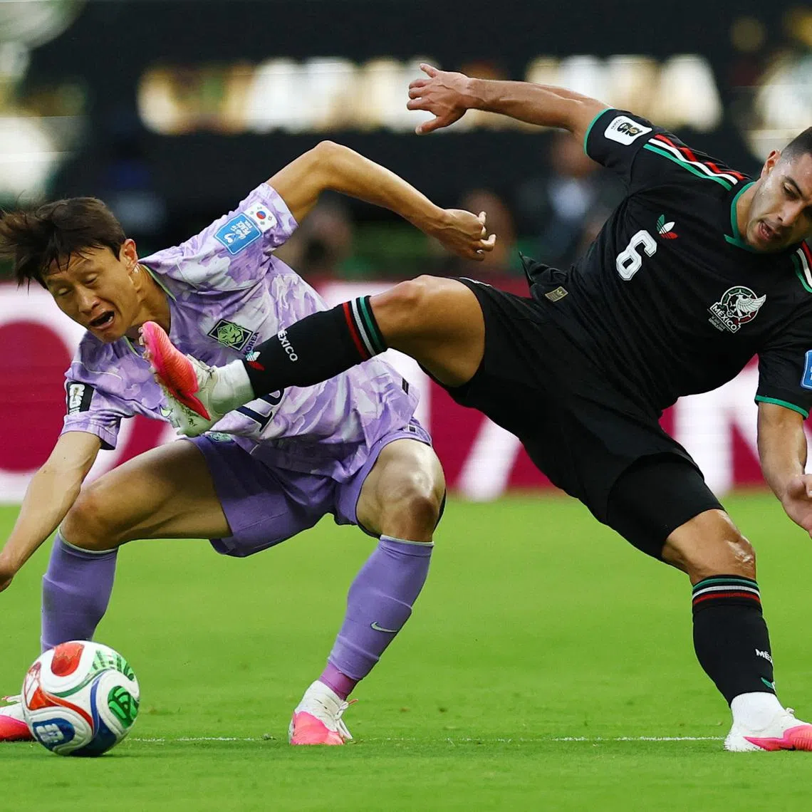 Soccer Football - FIFA World Cup 2026 - Group A - Mexico v South Korea - Estadio Guadalajara, Guadalajara, Mexico - June 18, 2026 South Korea's Lee Jae-sung in action with Mexico's Erik Lira REUTERS/Daniel Becerril