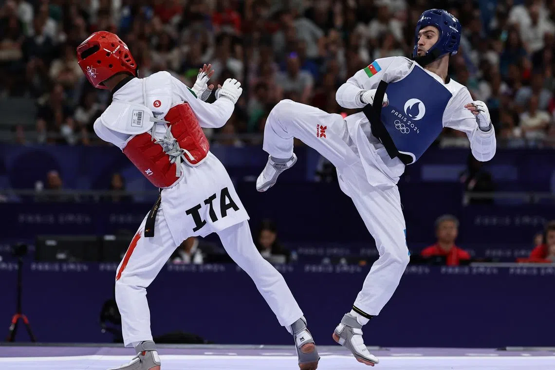 Paris 2024 Olympics - Taekwondo - Men -58kg Semifinal - Grand Palais, Paris, France - August 07, 2024. Gashim Magomedov of Azerbaijan in action against Vito Dell Aquila of Italy. REUTERS/Tingshu Wang