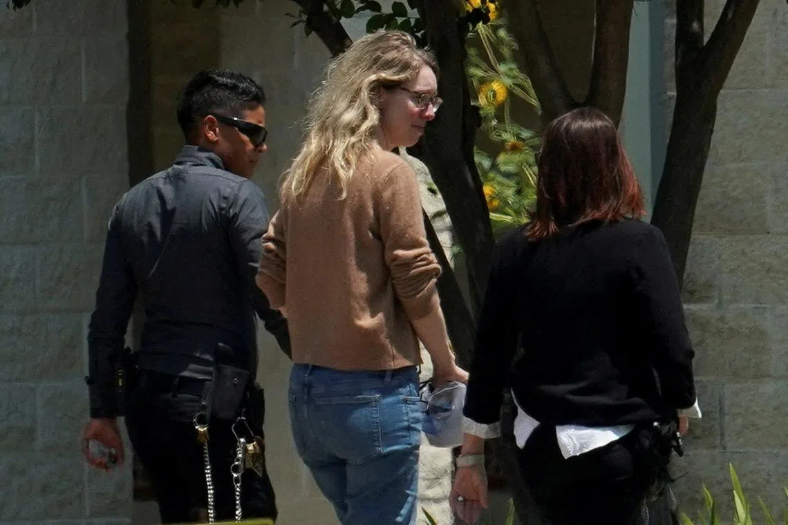 Elizabeth Holmes (centre) started Theranos as a college student and became its public face.