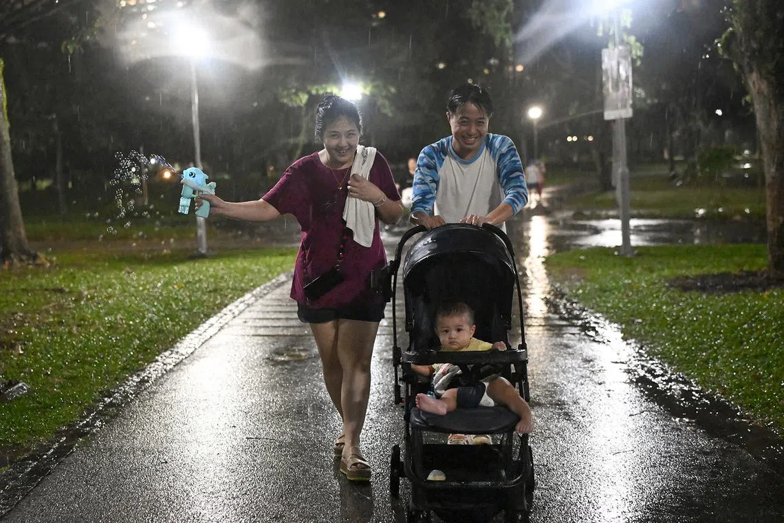 A family heading back home after it started to rain at Bishan-Ang Mo Kio Park on Sept 17, 2024. 