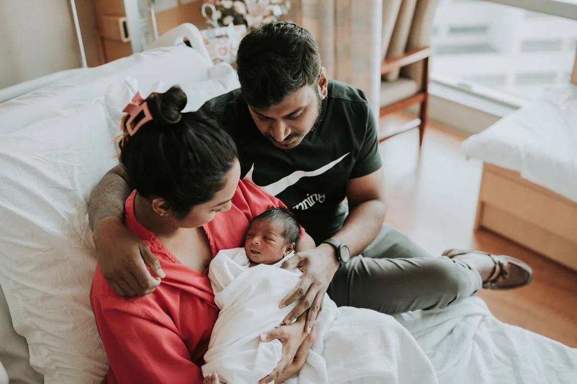Mdm Arathi Manogaran and her husband Mr Vinodan embracing their then newborn baby boy, Kieran, as first-time parents.