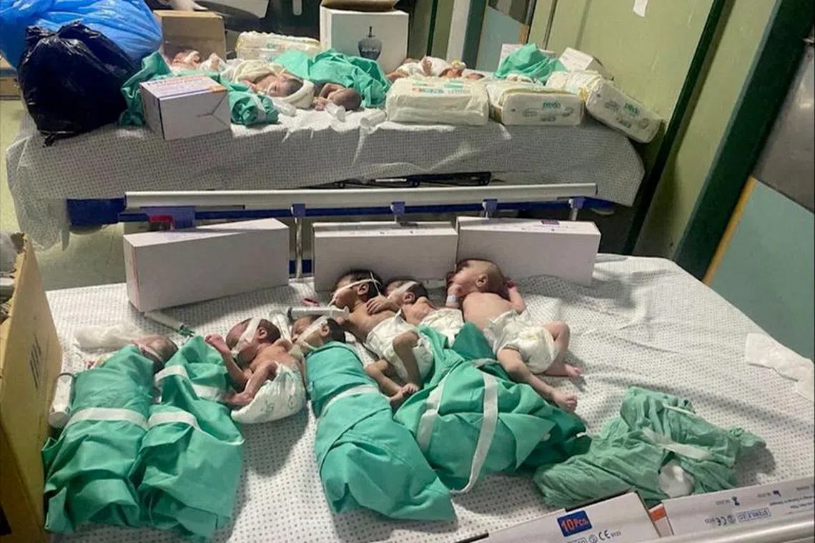 FILE PHOTO: Newborns are placed in bed after being taken off incubators in Gaza's Al Shifa hospital after power outage, amid the ongoing conflict between Israel and the Palestinian Islamist group Hamas, in Gaza City, Gaza November 12, 2023 in this still image obtained by REUTERS./File Photo