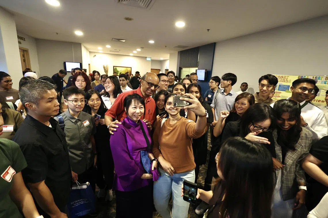 Presidential hopeful Tharman Shanmugaratnam and his wife Jane Yumiko Ittogi posing for photos with participants at a dialogue at YWCA Fort Canning on Aug 19.