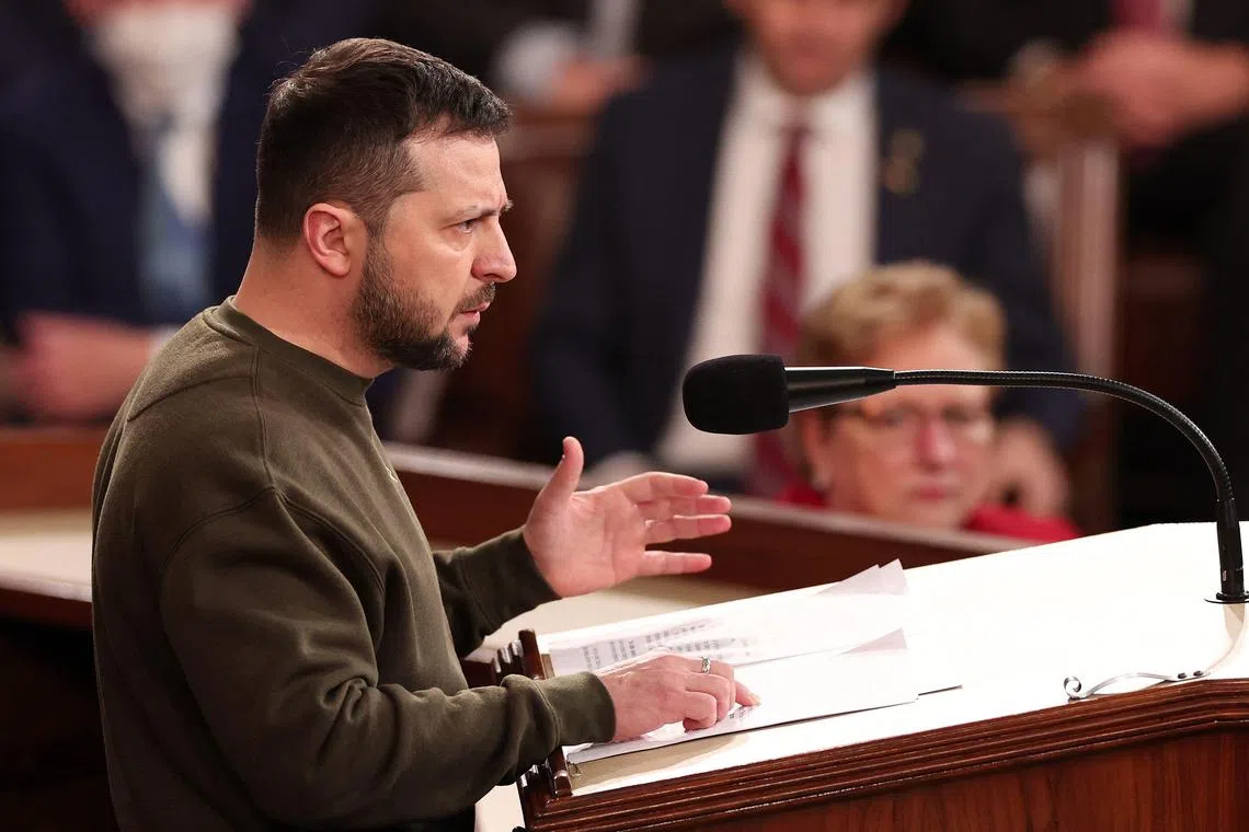 WASHINGTON, DC - DECEMBER 21: President of Ukraine Volodymyr Zelensky addresses a joint meeting of Congress in the House Chamber of the U.S. Capitol on December 21, 2022 in Washington, DC. In his first known trip outside of Ukraine since Russia invaded, Zelensky met with U.S. President Joe Biden and outlined Ukraine's request for continued military aid.   Win McNamee/Getty Images/AFP (Photo by WIN MCNAMEE / GETTY IMAGES NORTH AMERICA / Getty Images via AFP)