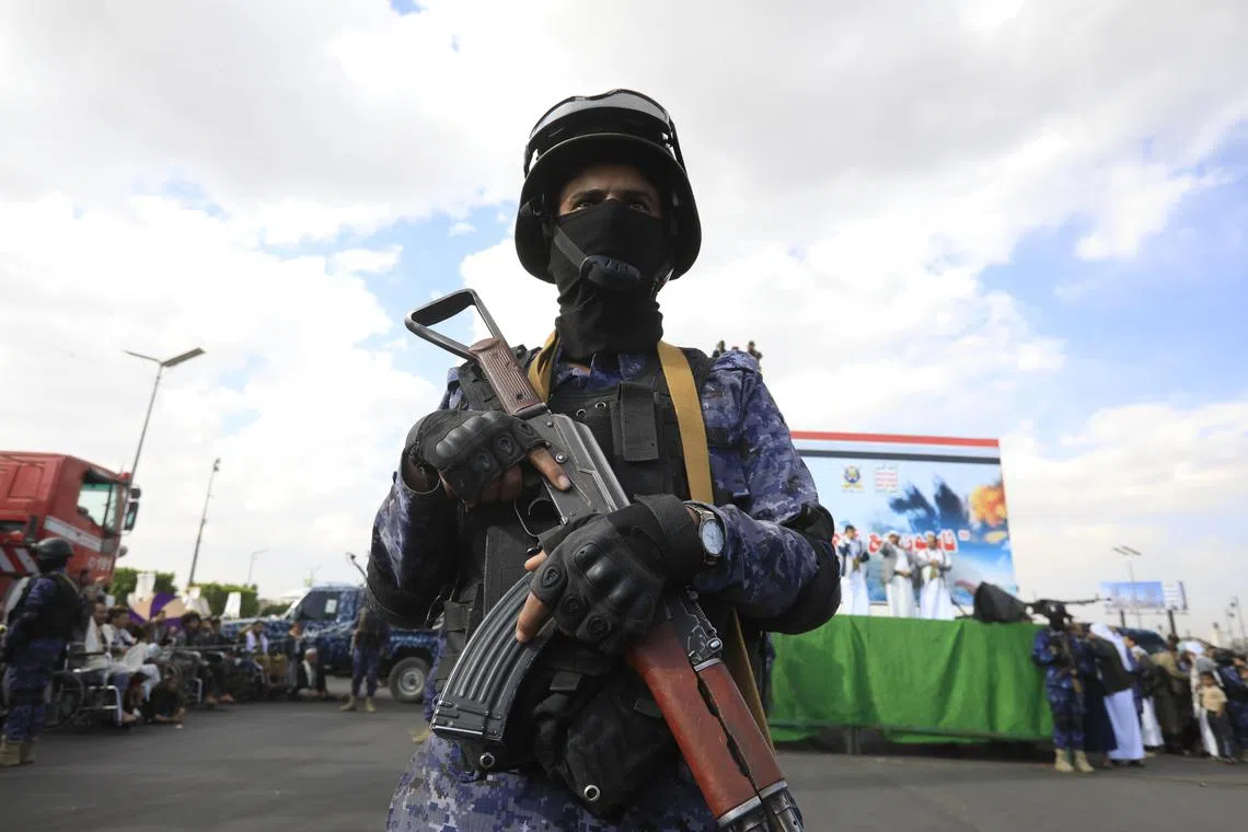 epa11970546 A Houthi soldier stands guard during a protest in Sana'a, Yemen, 17 March 2025 against US airstrikes on Houthi positions. Houthi supporters have taken to the streets of Sana'a to protest the airstrikes that targeted Houthi-held positions in several Yemeni cities on 15 March. The Houthis have vowed to target US ships in the Red Sea in retaliation for the recent US airstrikes that killed at least 53 people and wounded 98 others, according to a statement by Houthi military spokesman Yahya Sarea.  EPA-EFE/YAHYA ARHAB
