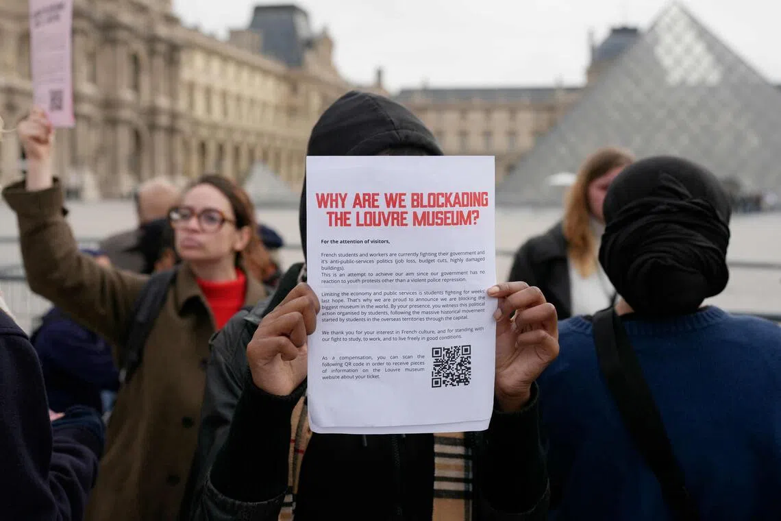 Students from the Ecole du Louvre block the entrance to Paris’ iconic Louvre Museum, the most visited in the world.