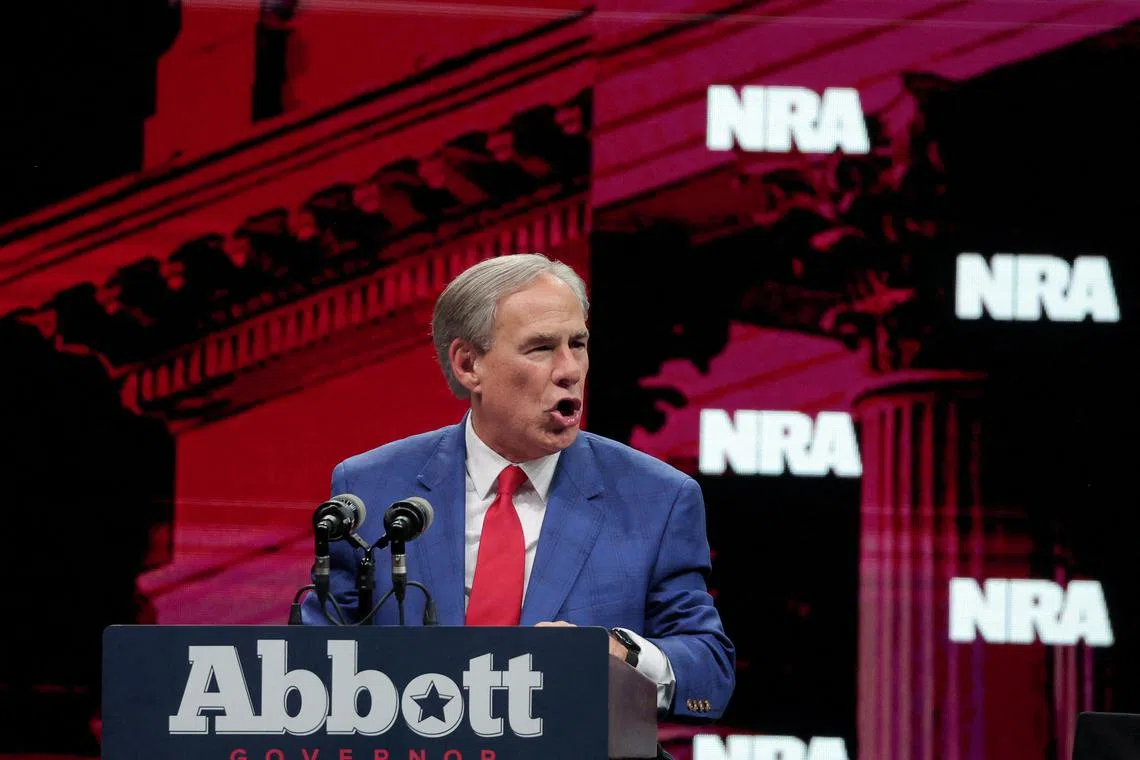 FILE PHOTO: Texas Governor Greg Abbott speaks during the annual National Rifle Association (NRA) meeting in Dallas, Texas, U.S., May 18, 2024. REUTERS/Carlos Barria/File Photo