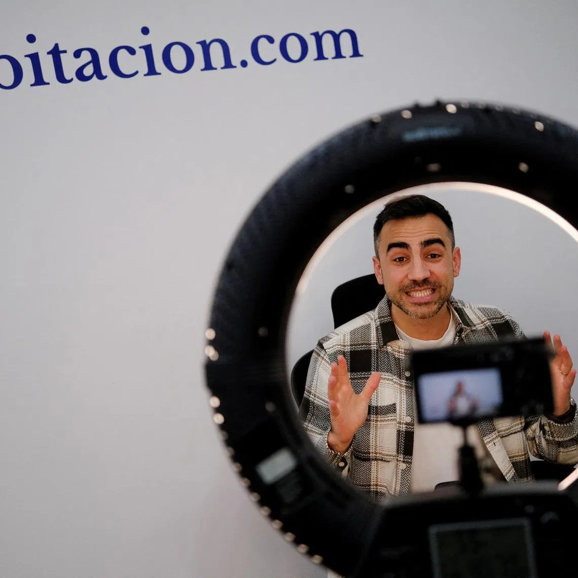 Oriol Valls, co founder and CEO of Spanish start-up Habitacion.com, who also provides property advice on Youtube, works at his headquarters in Barcelona, Spain, February 23, 2026. REUTERS/Nacho Doce