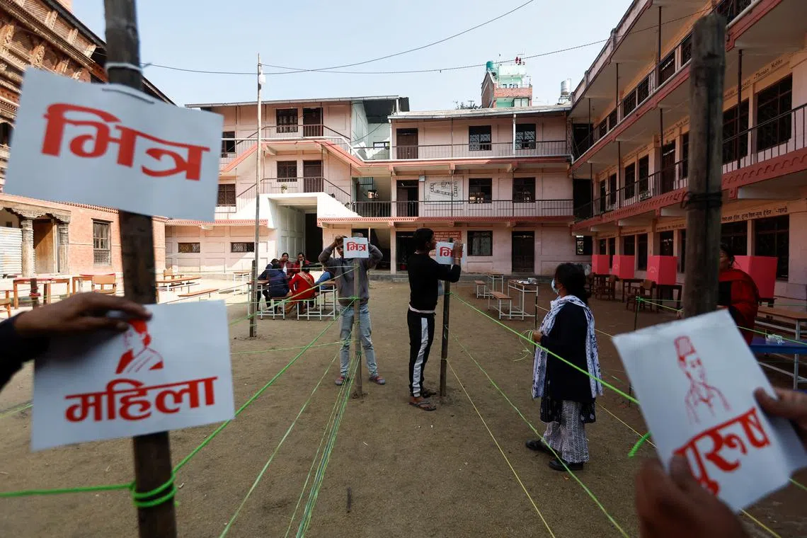 Officials from the election commission work to set up polling station a day ahead of the general elections, in Bhaktapur, Nepal, on Nov 19, 2022. 