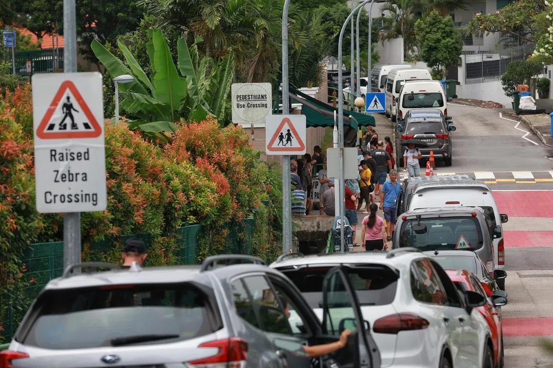 Minibuses, cars of parents and private hire cars seen parked outside St Stephen’s School on Jan 26, 2023.