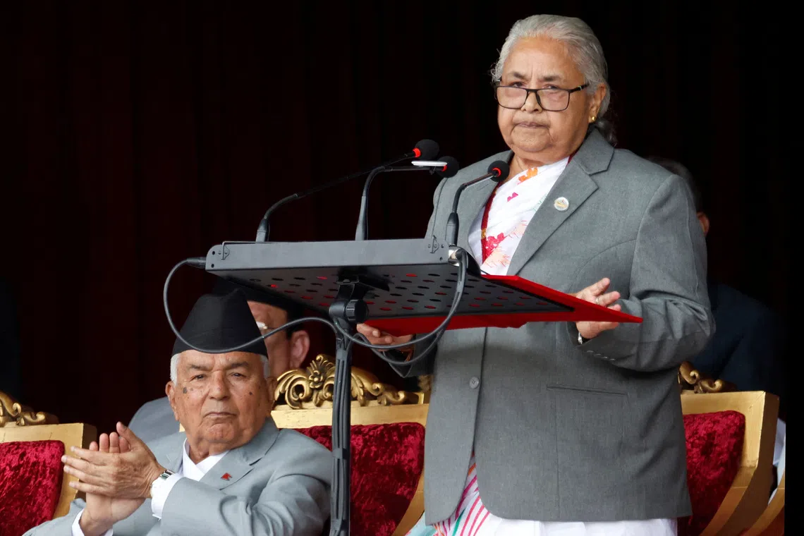 Nepal's interim Prime Minister Sushila Karki addresses as President Ram Chandra Paudel applauds while attending the Constitution Day at the Army Pavilion in Tundikhel, Kathmandu, Nepal, September 19, 2025. REUTERS/Stringer