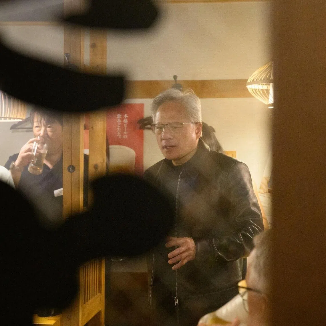 Chief executive officer of Nvidia Corp Jensen Huang (right) with local suppliers at an izakaya restaurant in Tokyo, Japan.