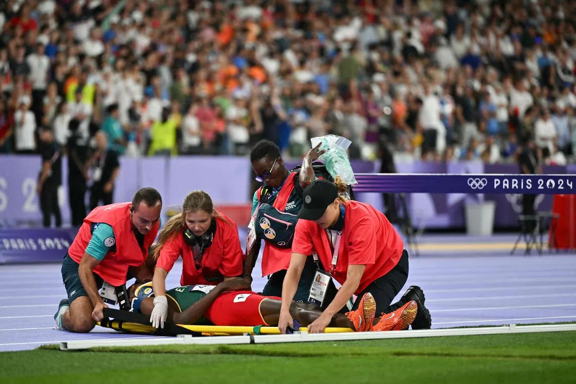 Ethiopia's Lamecha Girma receives medical attention after a bad fall in the men's 3,000m steeplechase final at the Paris  Olympic Games at Stade de France on Aug 7, 2024.